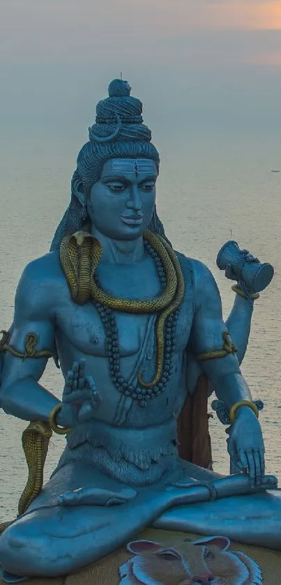 Shiva statue overlooking ocean at sunset, serene mobile wallpaper.