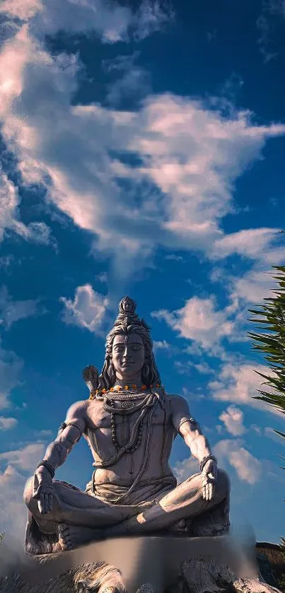 Lord Shiva meditating under a blue sky with clouds and greenery.