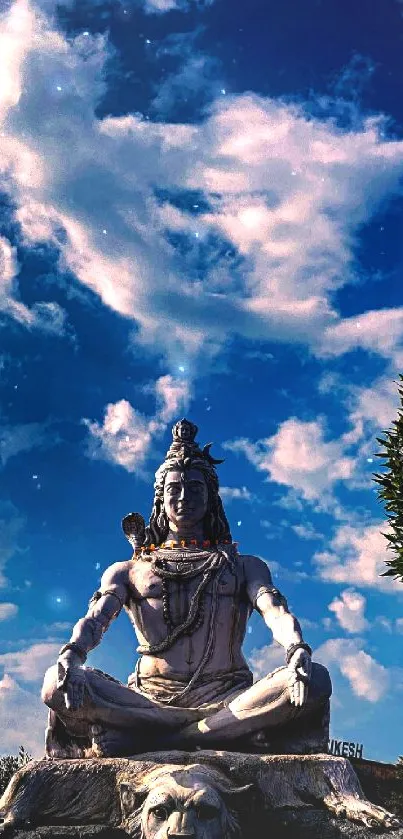 Shiva statue under a vibrant blue sky.