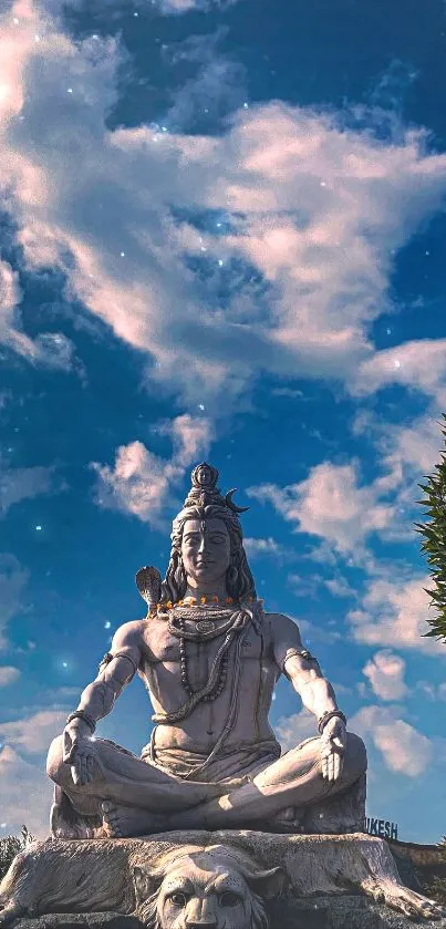 Statue of Lord Shiva under a dramatic blue sky.