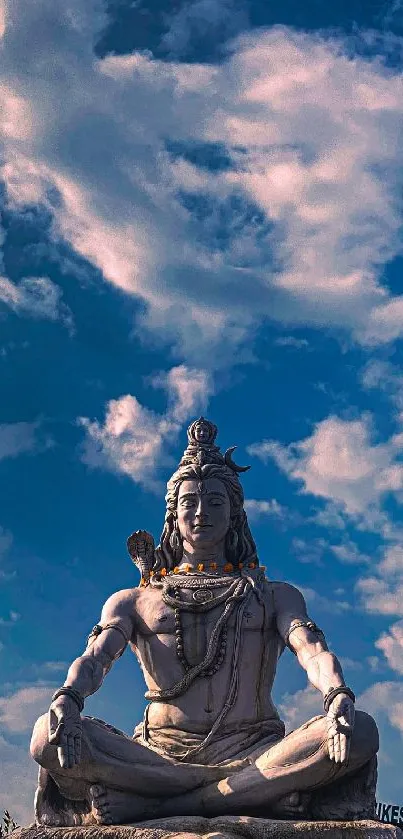 Majestic Shiva statue under a vibrant blue sky.