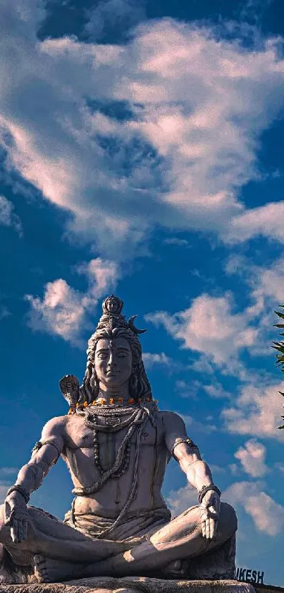 Lord Shiva meditating under the blue sky.