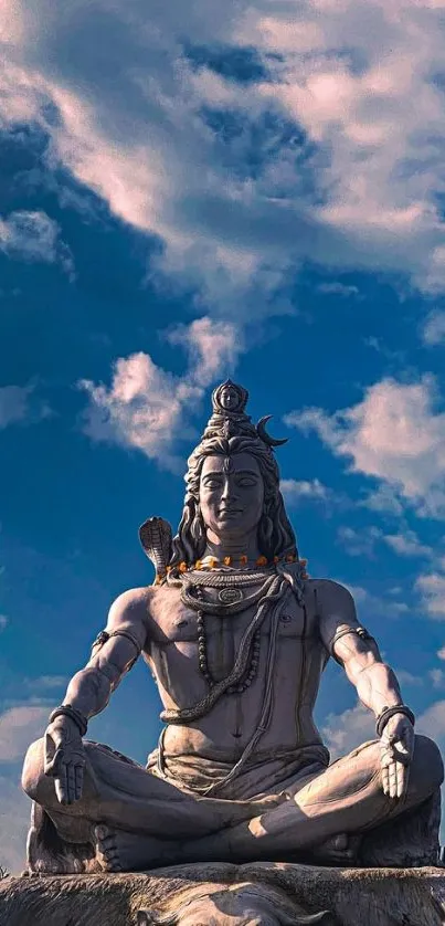 Serene Shiva statue under a blue sky.