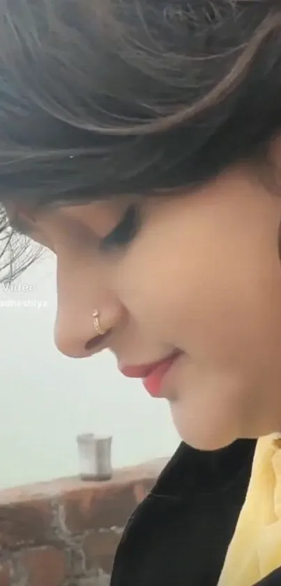 Serene side profile of a woman with colorful earrings.