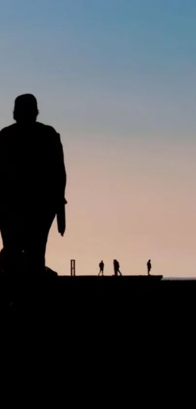 Silhouette figures against a colorful sunset sky on a tranquil evening.