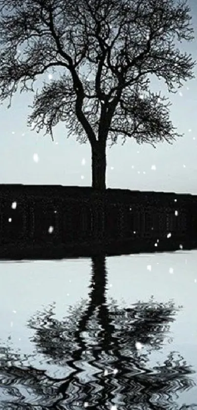 Serene silhouette of a tree with snowflakes and reflection.