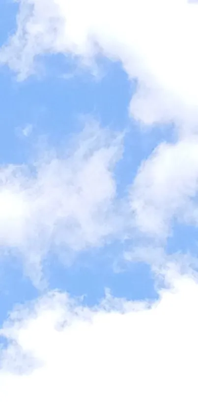 Bright blue sky with fluffy white clouds.