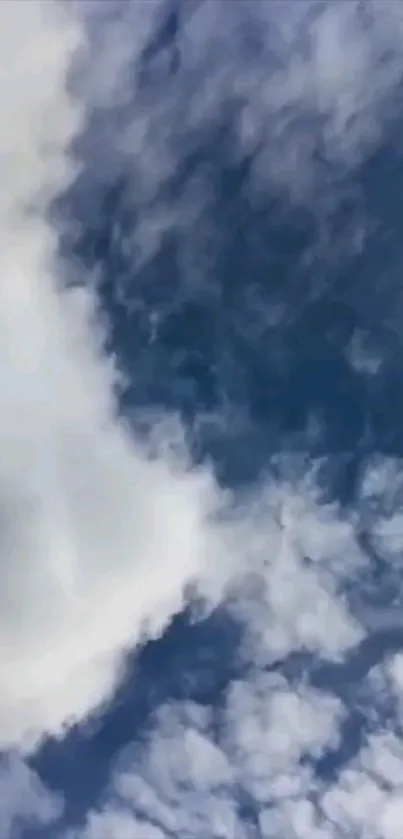 Serene sky with fluffy white clouds on a deep blue background.