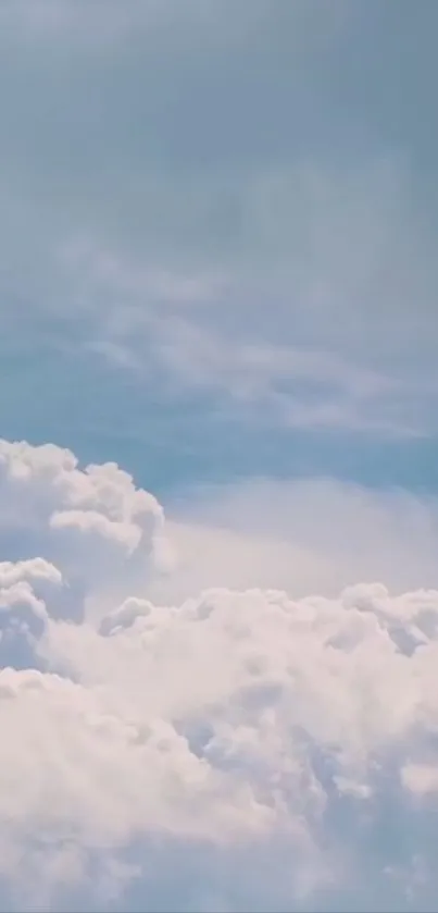 Fluffy white clouds in a serene blue sky wallpaper.