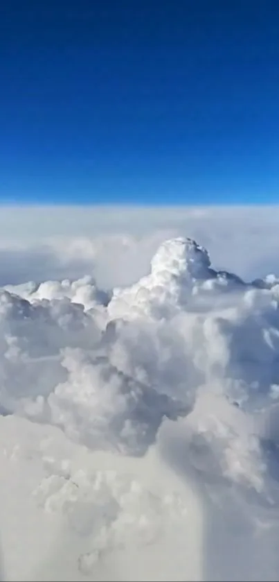 Fluffy white clouds under a deep blue sky.