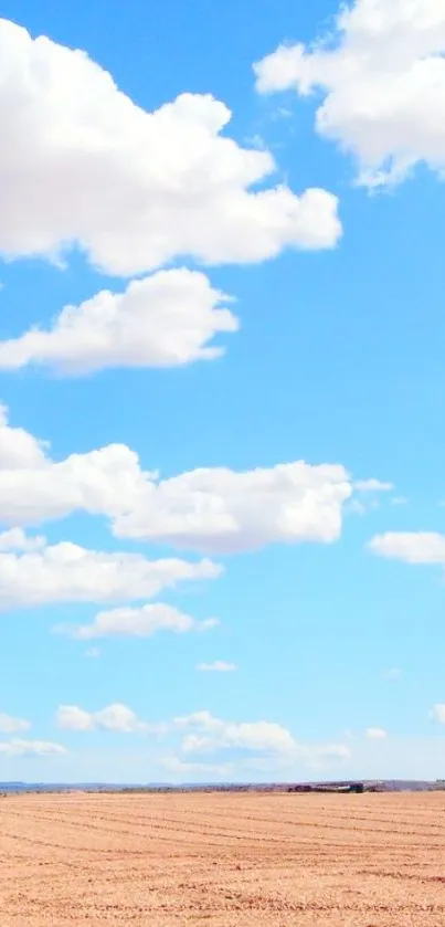 Serene mobile wallpaper of a blue sky over a peaceful field with fluffy clouds.