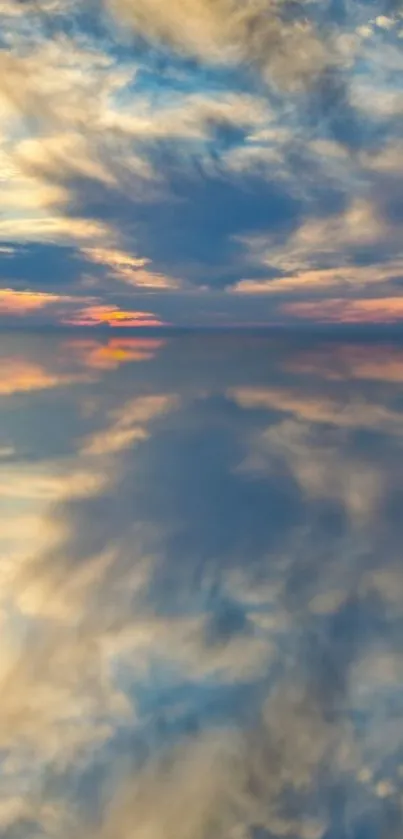 Reflection of a serene sunset sky over calm water.