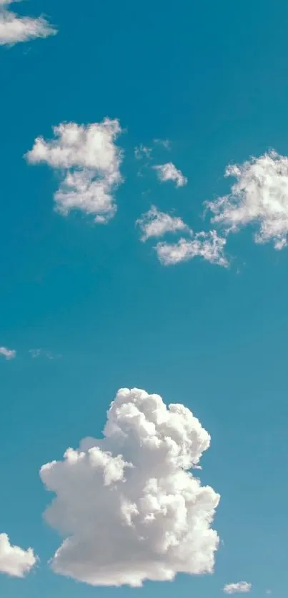 Fluffy white clouds against a clear blue sky.