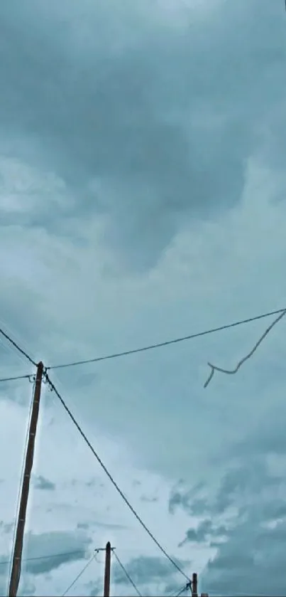 Serene sky with clouds and power lines in blue tones.