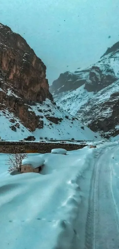 Serene snowy road through majestic mountains, capturing winter's essence.