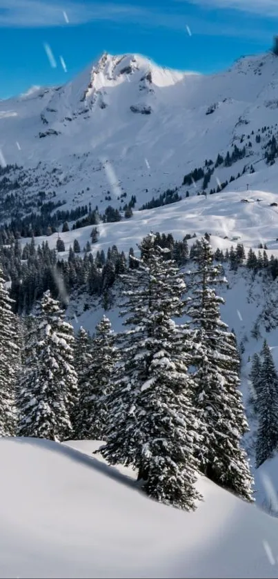 Snow-covered mountains and trees under a bright blue sky with falling snowflakes.