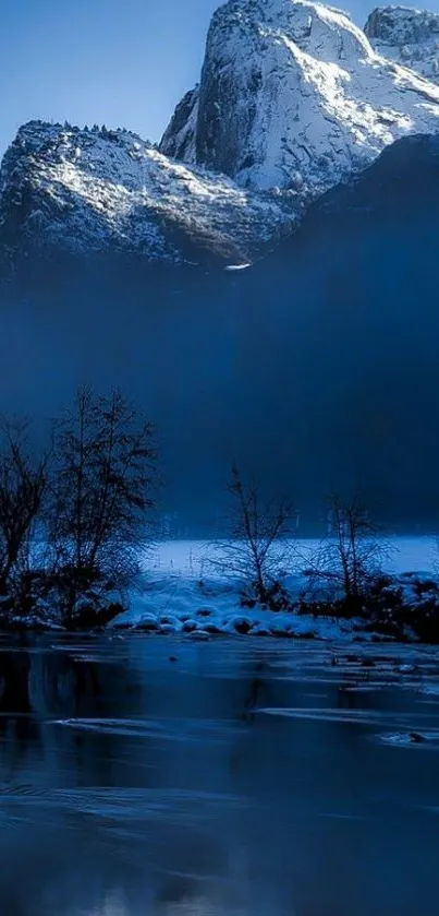 Snowy mountain reflected in a calm blue lake at dawn.