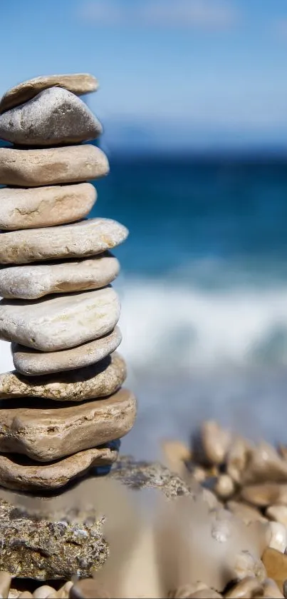 Stacked rocks on a beach with an ocean backdrop.