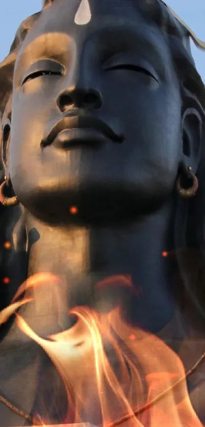 Serene statue with flames wallpaper for mobile device.