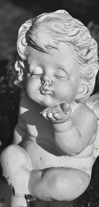 Monochrome stone angel sculpture in a serene garden setting.