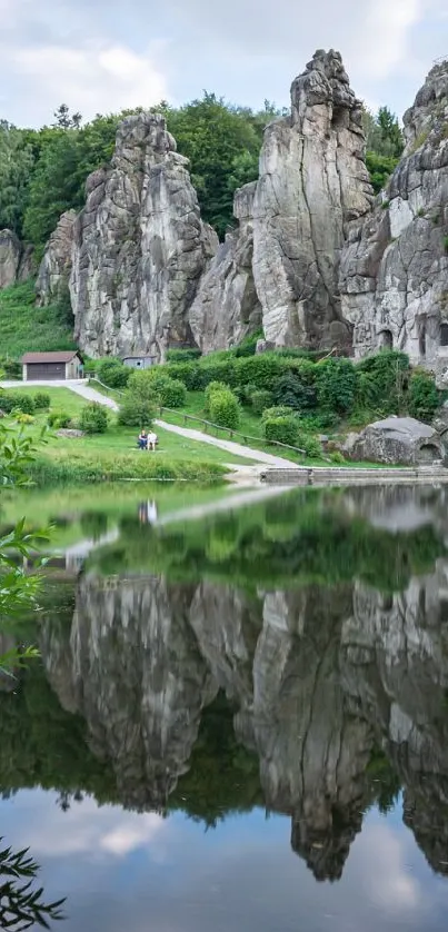 Stone formations reflected in tranquil water surrounded by lush greenery.