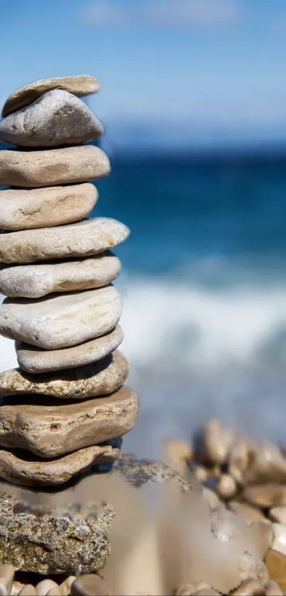 Stack of stones on a serene beach with blue sea waves.