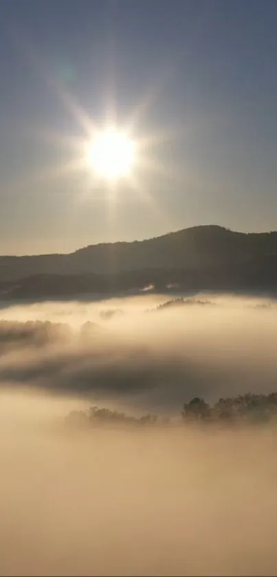 Sunlit mountain landscape with mist and a bright sunrise.