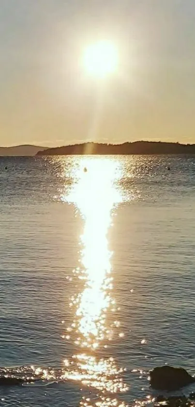 Golden sunset reflecting on the ocean, creating a serene and peaceful scene.