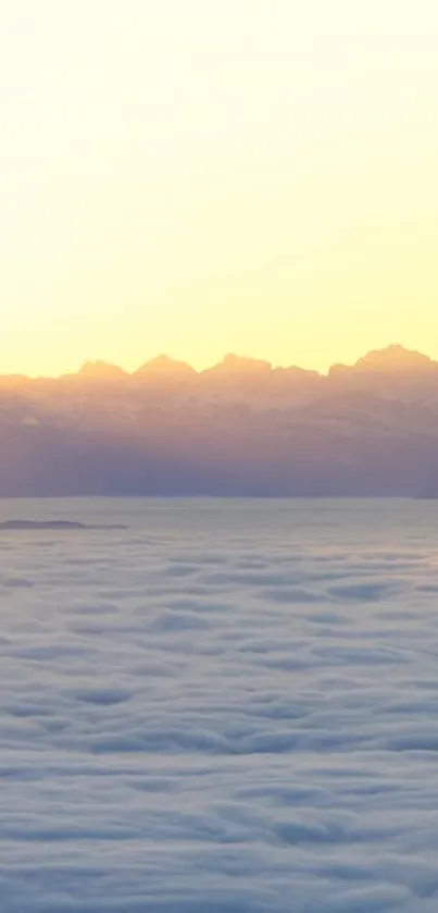 Mobile wallpaper of a sunrise over misty mountains.