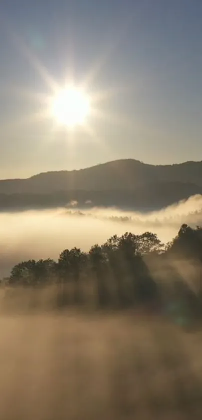 Sunrise over misty hills with sunlight streaming through clouds.