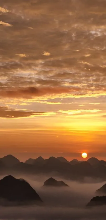 Golden sunrise over mountains with clouds and a serene atmosphere.