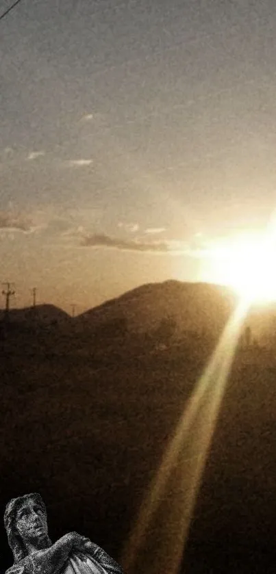 Serene sunset over mountains with angel statue.