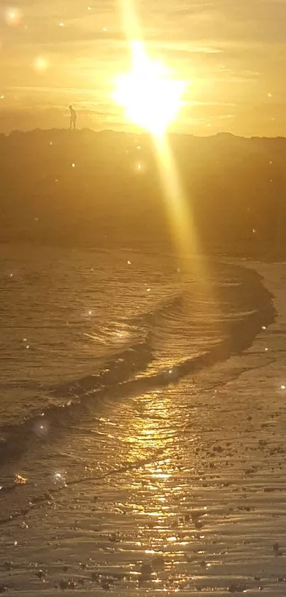 Golden sunset over calm beach waves with reflecting light.