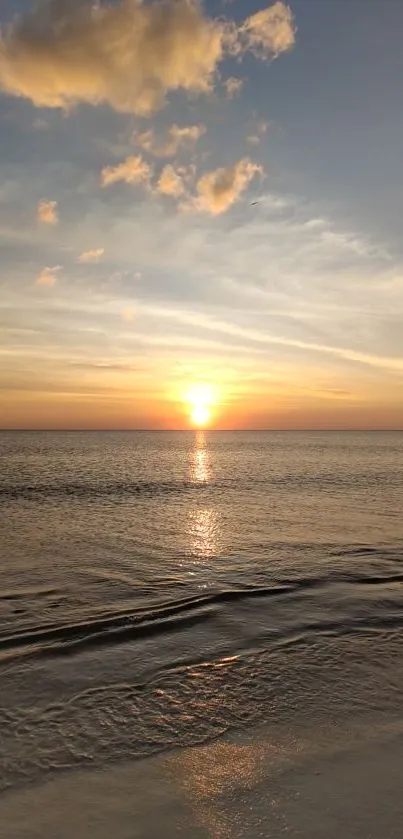 Serene sunset over a tranquil beach, perfect for a calming phone wallpaper.