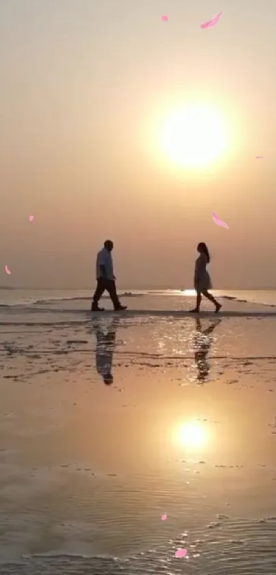 Couple walking on beach at sunset with serene reflections.