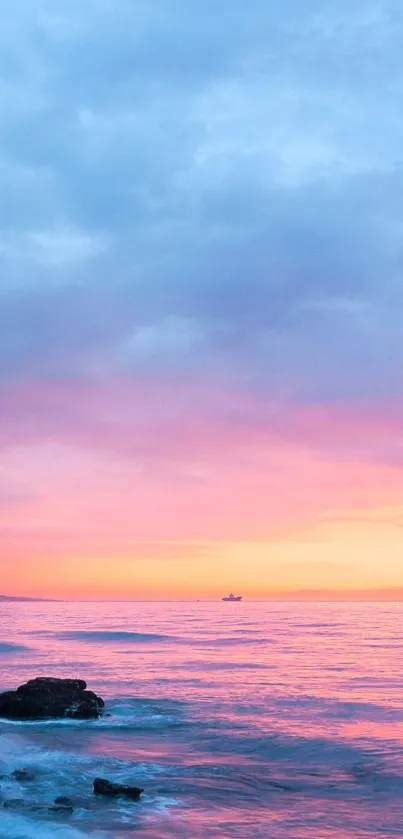 Serene sunset over a tranquil beach with pink and blue hues.