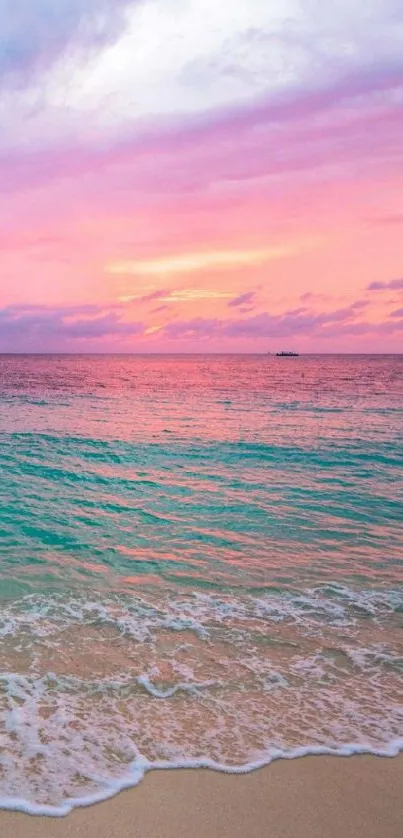 Calm beach during pink and blue sunset with gentle waves.