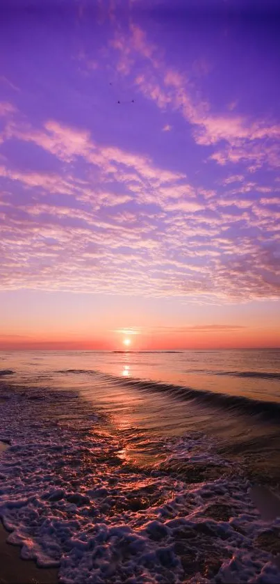 A serene beach with a vibrant purple sunset over the ocean waves.