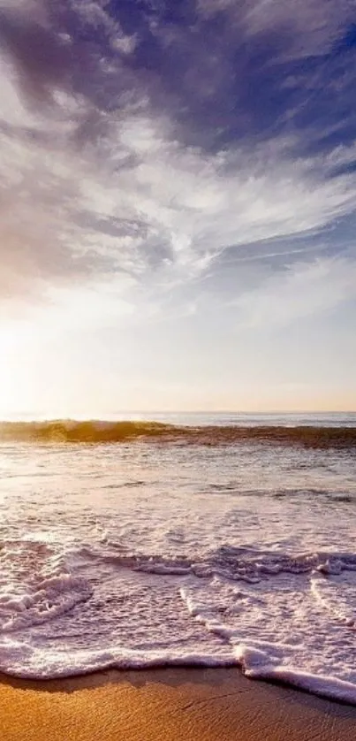 Serene beach at sunset with waves and vibrant sky.