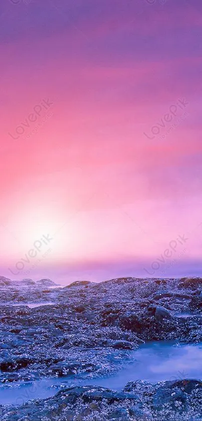 Pink and purple sunset beach wallpaper with rocky shore and ocean.