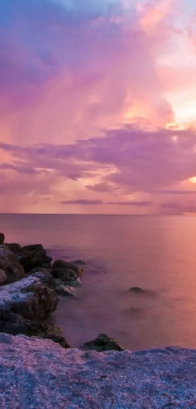 A serene beach sunset with vibrant purple and orange hues.