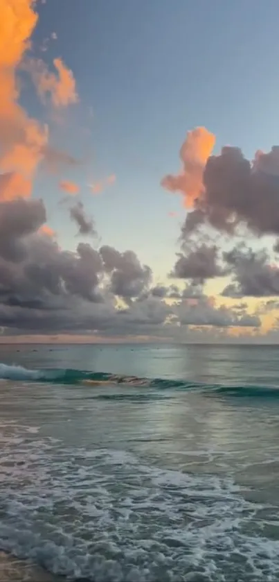 Tranquil beach at sunset with vibrant clouds and soothing ocean waves.