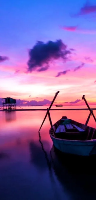 Calm boat in a vibrant purple and pink sunset reflected on the water.