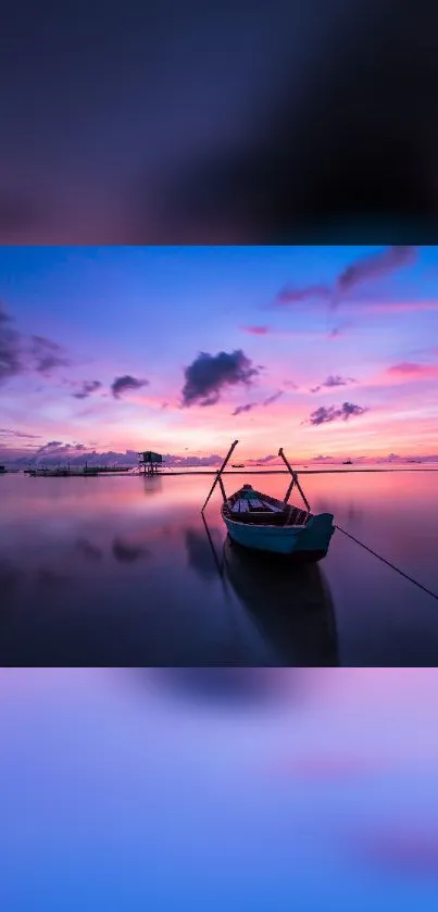 Tranquil boat at sunset on purple-pink waters.