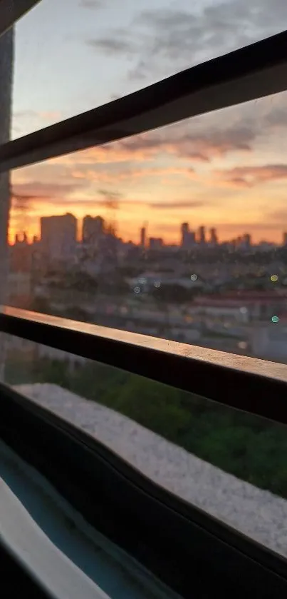 Mobile wallpaper depicting sunset city view through a window frame.