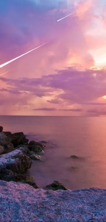 Serene sunset over a rocky coast with vibrant sky and ocean view.