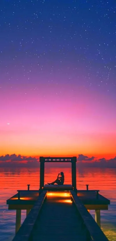 Serene sunset over dock with starry sky.