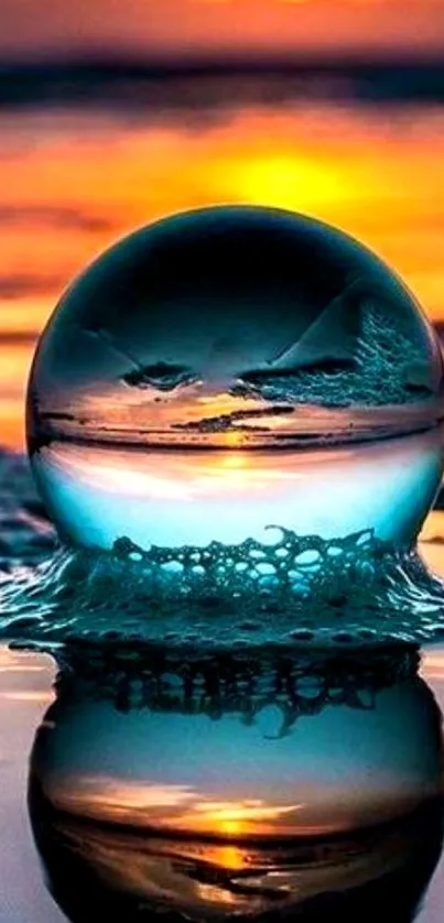 Crystal globe reflecting sunset over ocean waves.