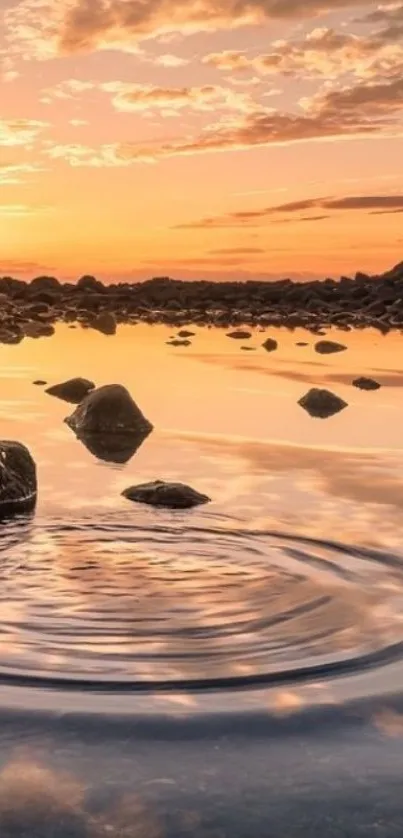 A serene sunset reflection over a tranquil lake with scattered rocks.