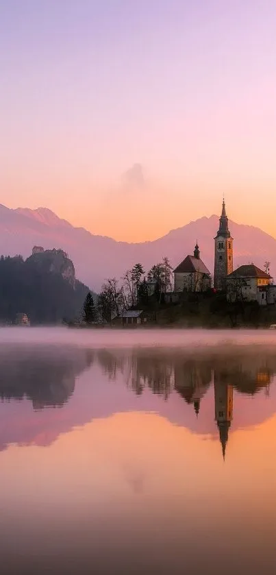 Serene sunset reflecting on a misty lake with mountains in the background.